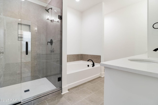 bathroom featuring separate shower and tub, tile patterned flooring, and vanity