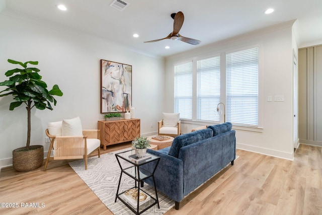 living room with ceiling fan, light hardwood / wood-style floors, and ornamental molding