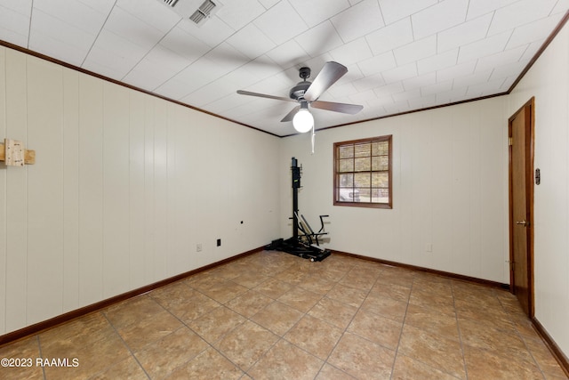 spare room with ornamental molding and ceiling fan