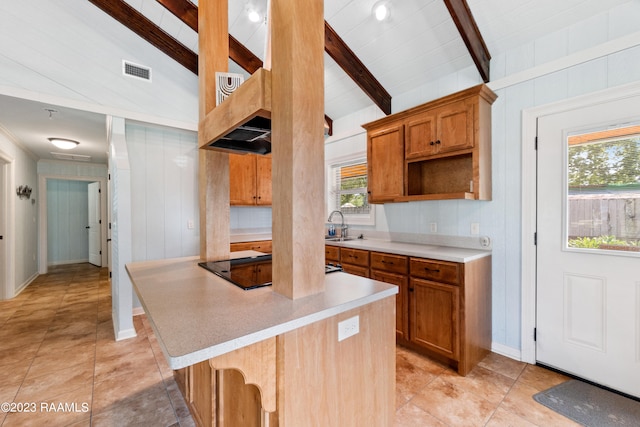 kitchen featuring a breakfast bar, sink, wood walls, vaulted ceiling with beams, and black electric stovetop