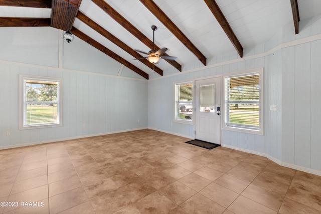 unfurnished living room featuring lofted ceiling with beams and ceiling fan