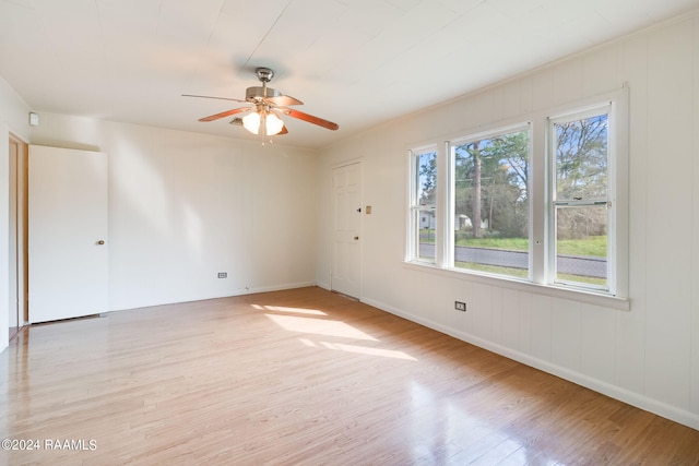 spare room featuring light hardwood / wood-style floors and ceiling fan