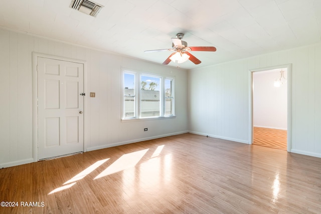 spare room featuring ceiling fan and light hardwood / wood-style flooring