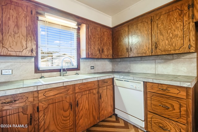 kitchen with dark parquet floors, sink, ornamental molding, white dishwasher, and tasteful backsplash