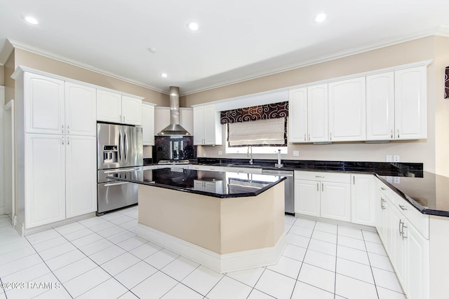 kitchen with a center island, stainless steel appliances, light tile floors, white cabinetry, and wall chimney exhaust hood