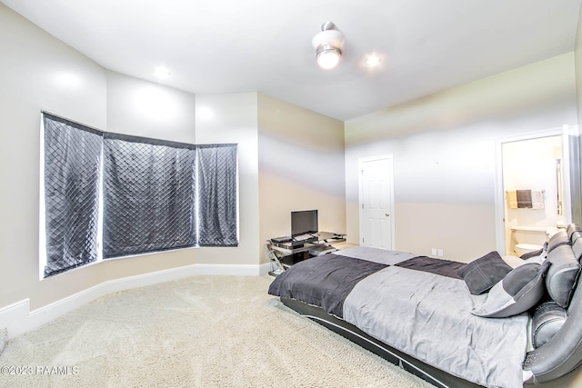 carpeted bedroom featuring connected bathroom