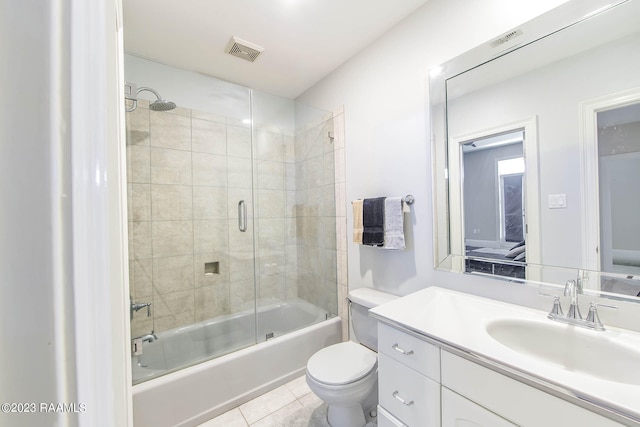 full bathroom featuring tile flooring, toilet, large vanity, and enclosed tub / shower combo