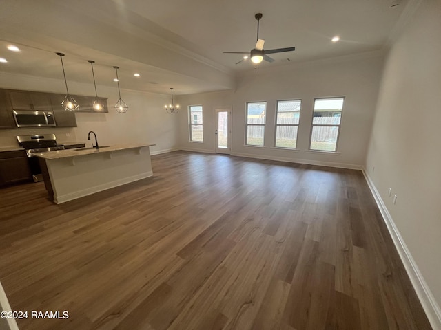 unfurnished living room with a wealth of natural light, ceiling fan with notable chandelier, crown molding, sink, and dark hardwood / wood-style floors