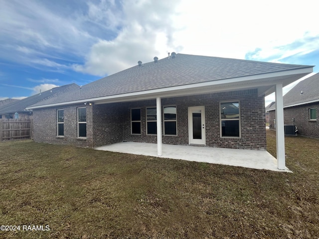 back of house with a yard, central AC unit, and a patio area