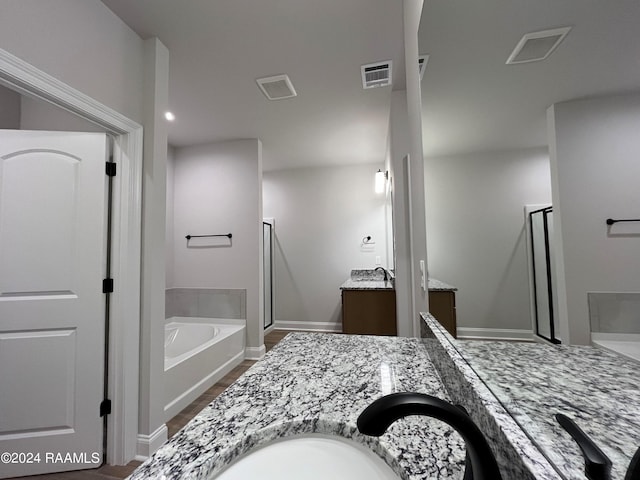 bathroom featuring oversized vanity and shower with separate bathtub