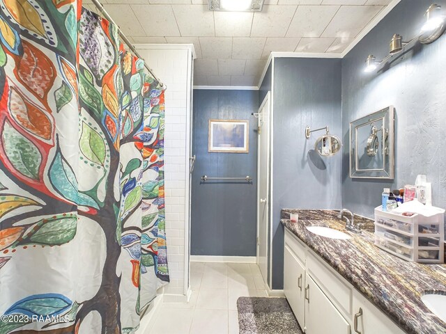 bathroom featuring tile patterned flooring, vanity, curtained shower, and ornamental molding