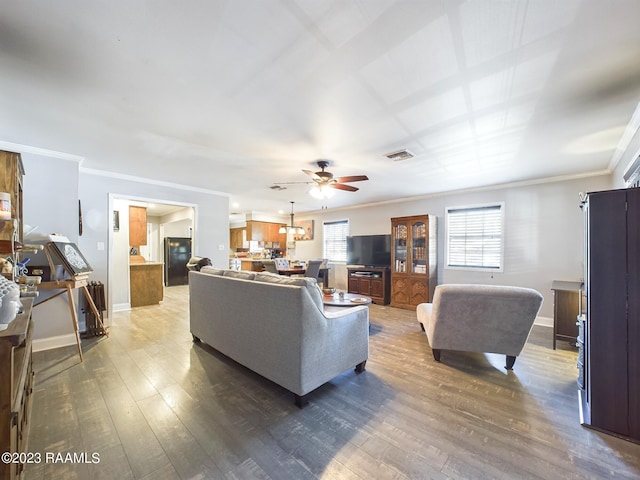 living room with wood-type flooring, ceiling fan, and ornamental molding