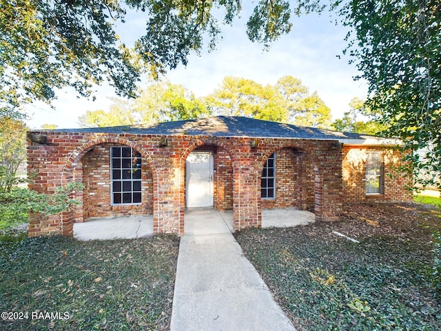 view of front of property with a patio and a front yard