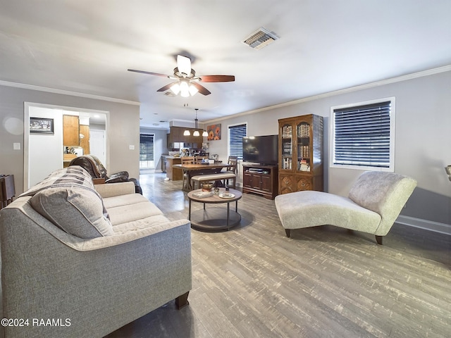 living room with crown molding, ceiling fan, and hardwood / wood-style flooring