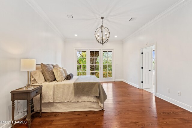 bedroom with dark hardwood / wood-style floors, ornamental molding, and a chandelier