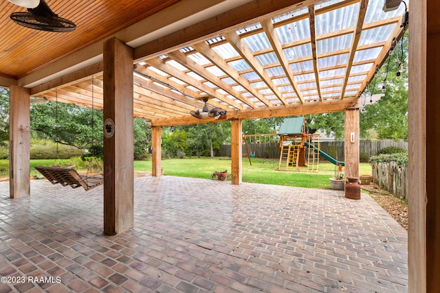 view of terrace with a pergola and a playground