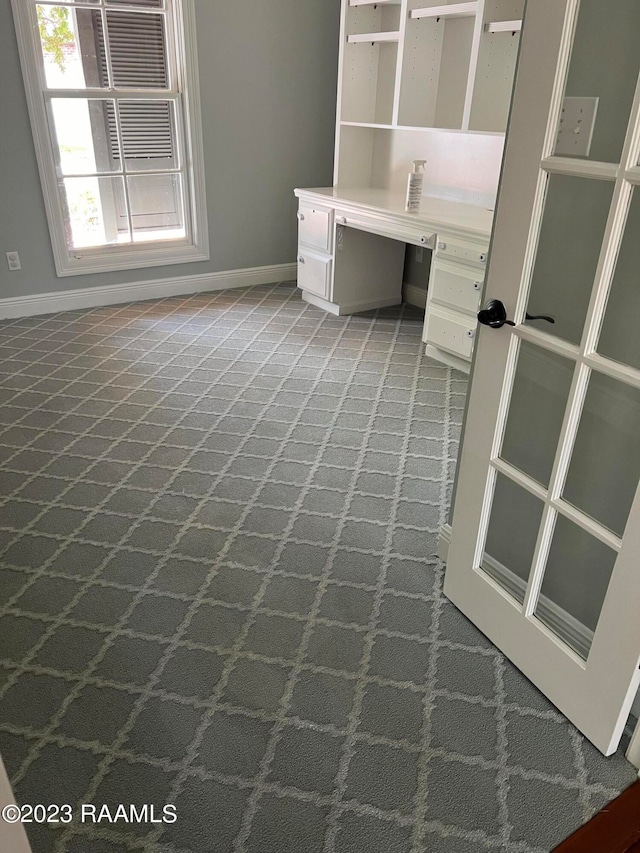 interior space with built in desk and carpet floors