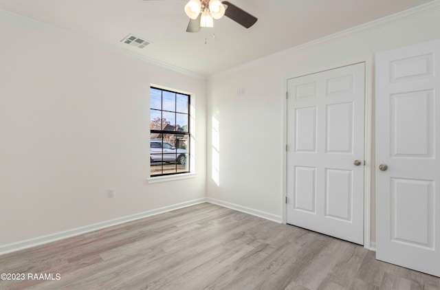 unfurnished bedroom featuring crown molding and light wood-type flooring