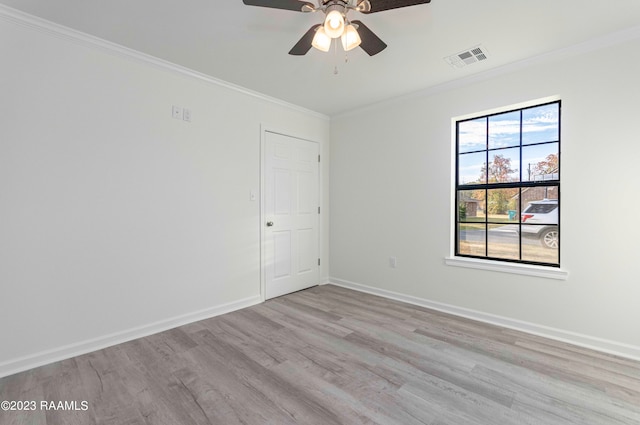 spare room featuring crown molding, light hardwood / wood-style floors, and ceiling fan