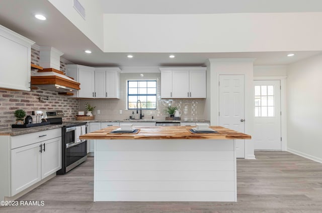 kitchen featuring appliances with stainless steel finishes, tasteful backsplash, white cabinets, and sink