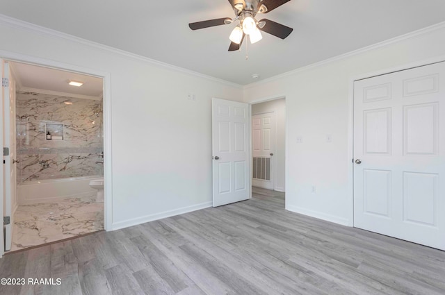 unfurnished bedroom featuring ceiling fan, light hardwood / wood-style flooring, ensuite bathroom, and ornamental molding