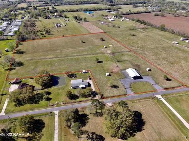 birds eye view of property with a rural view