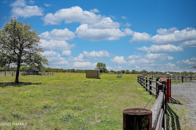 view of yard featuring a storage unit and a rural view