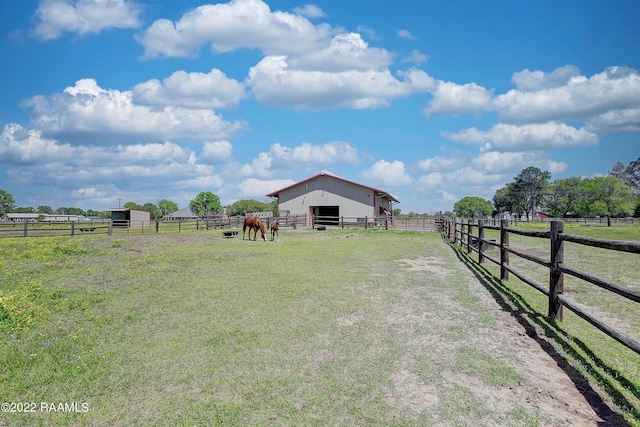 view of yard featuring a rural view and an outdoor structure