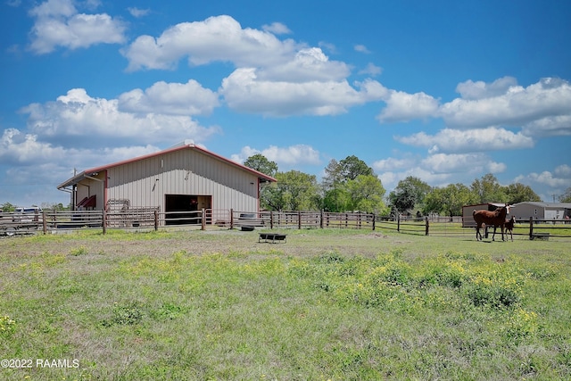 view of yard featuring a rural view and an outdoor structure