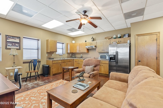 tiled living room with ceiling fan, a drop ceiling, and sink