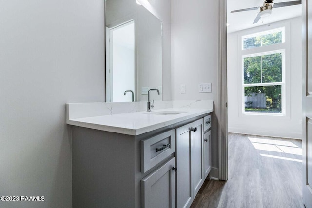 bathroom with vanity, ceiling fan, and hardwood / wood-style flooring