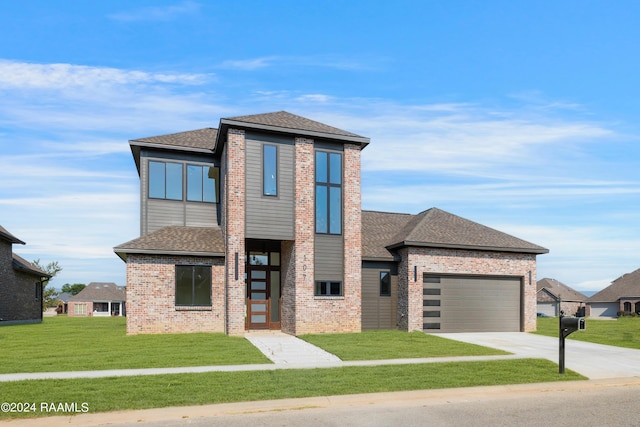 view of front of home featuring a garage and a front lawn