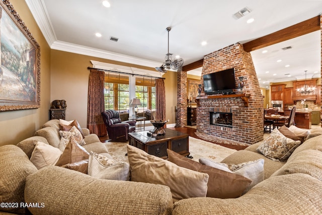 living room with a fireplace, hardwood / wood-style flooring, crown molding, and a notable chandelier