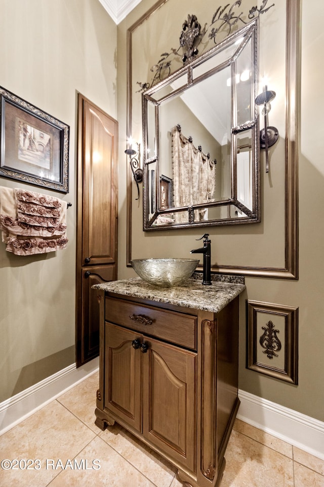 bathroom featuring tile patterned floors, crown molding, and vanity