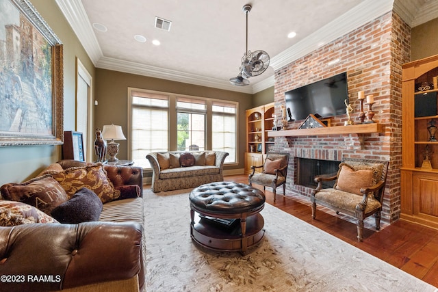 living room featuring hardwood / wood-style flooring, a brick fireplace, and crown molding