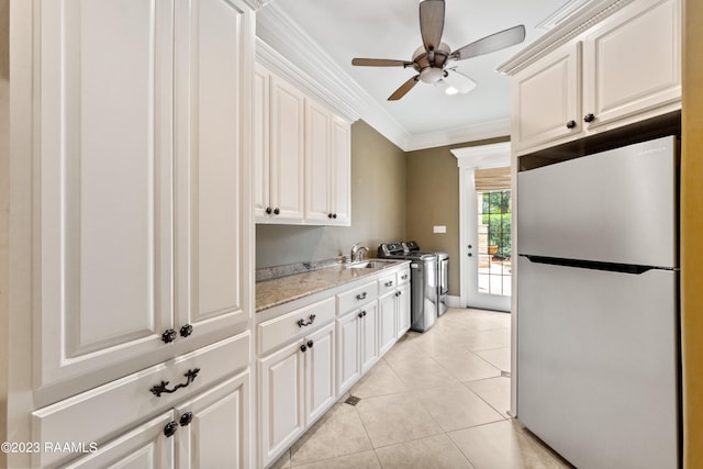 kitchen featuring stainless steel refrigerator, white cabinetry, and crown molding