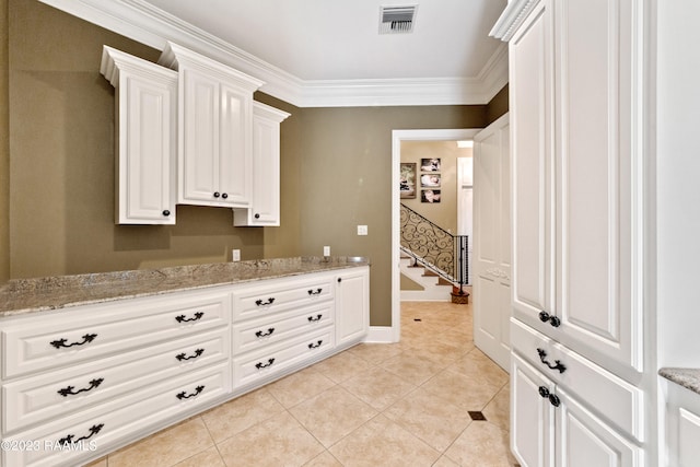 laundry room featuring light tile patterned flooring and ornamental molding