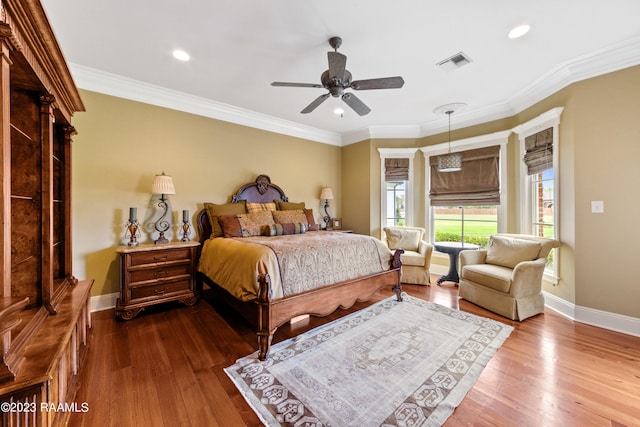 bedroom featuring wood-type flooring, ceiling fan, and ornamental molding