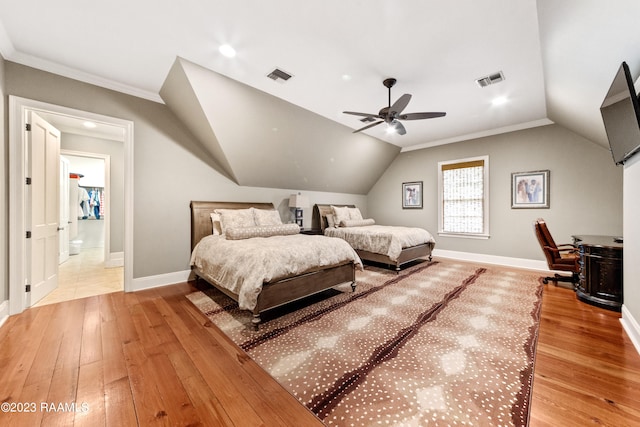 bedroom with vaulted ceiling, light hardwood / wood-style flooring, ceiling fan, and crown molding