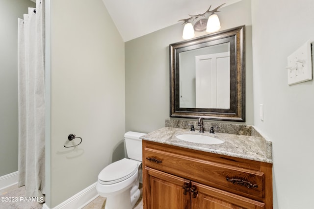 bathroom with tile patterned floors, vanity, vaulted ceiling, and toilet