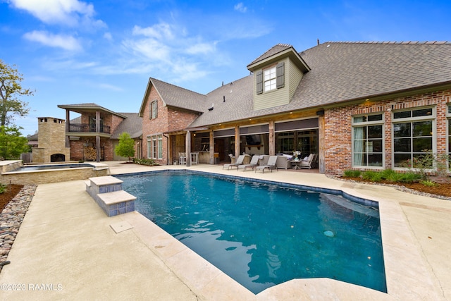 view of swimming pool with a fireplace and a patio