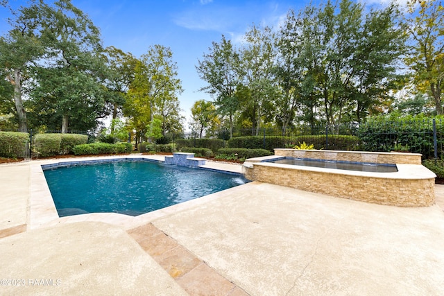 view of pool with an in ground hot tub, pool water feature, and a patio