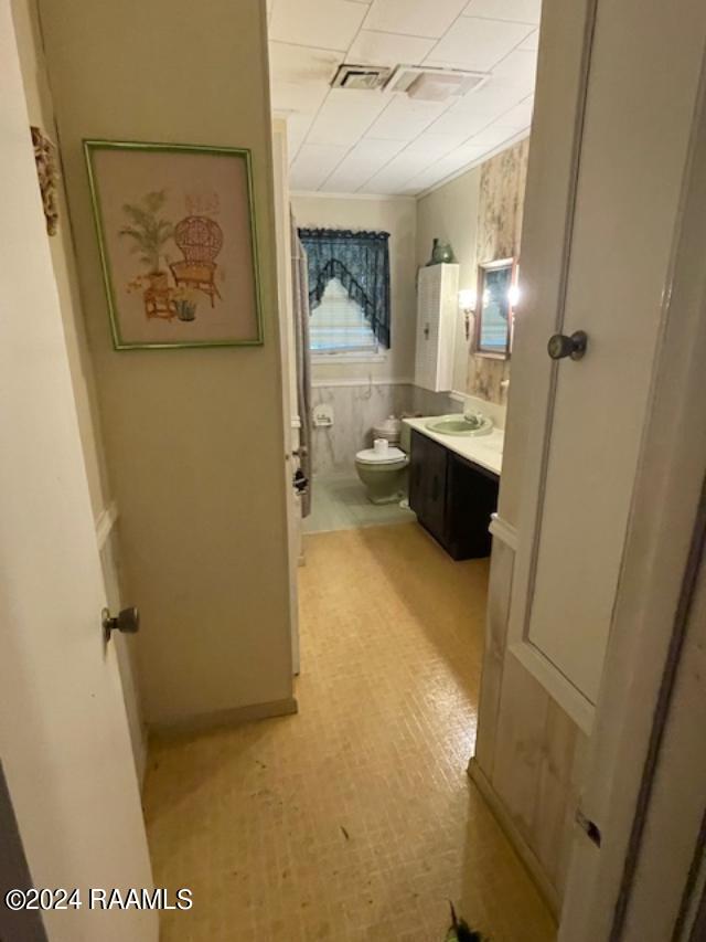 105 S 1st St, Gueydan, LA 70542 - bathroom featuring toilet, visible vents, vanity, and a paneled ceiling