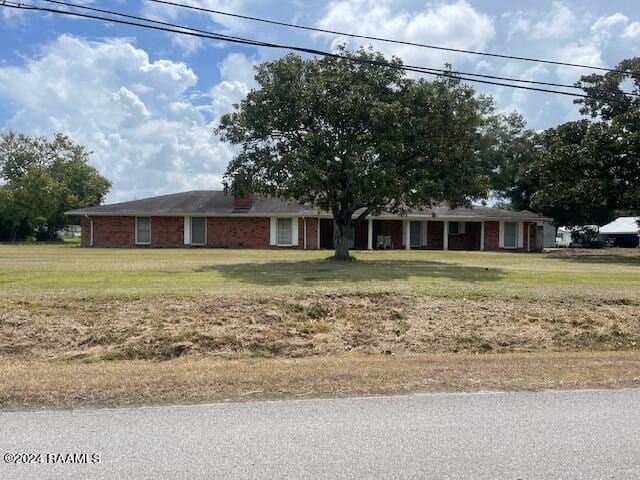 ranch-style house with a front lawn and brick siding