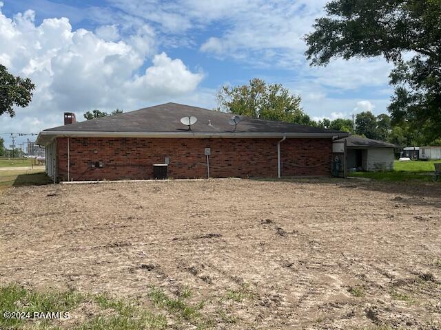 105 S 1st St, Gueydan, LA 70542 - back of property featuring a chimney and brick siding