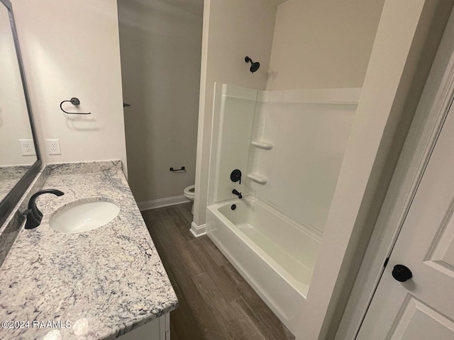 full bathroom featuring toilet, shower / washtub combination, vanity, and hardwood / wood-style floors