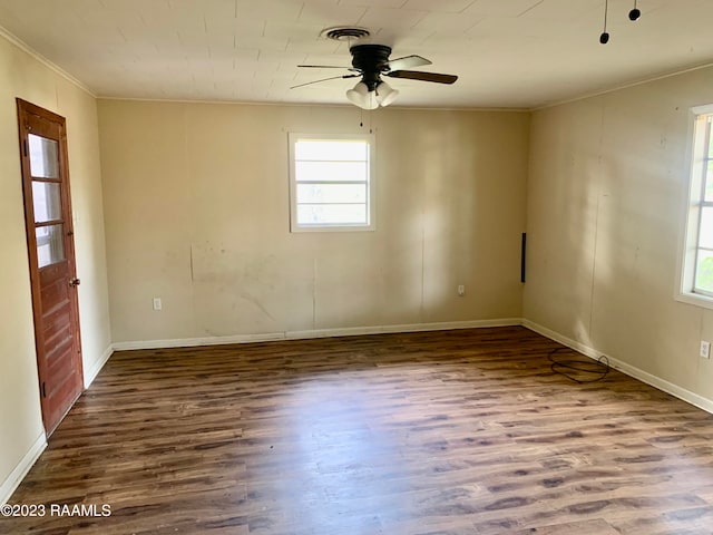 empty room with ceiling fan, dark wood-type flooring, and a healthy amount of sunlight