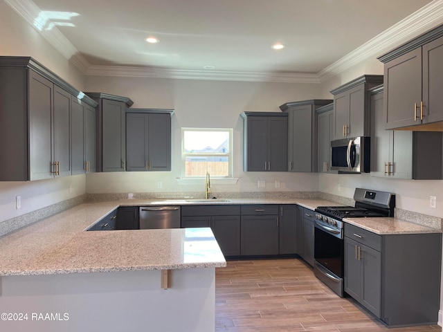 kitchen featuring gray cabinetry, sink, ornamental molding, appliances with stainless steel finishes, and kitchen peninsula