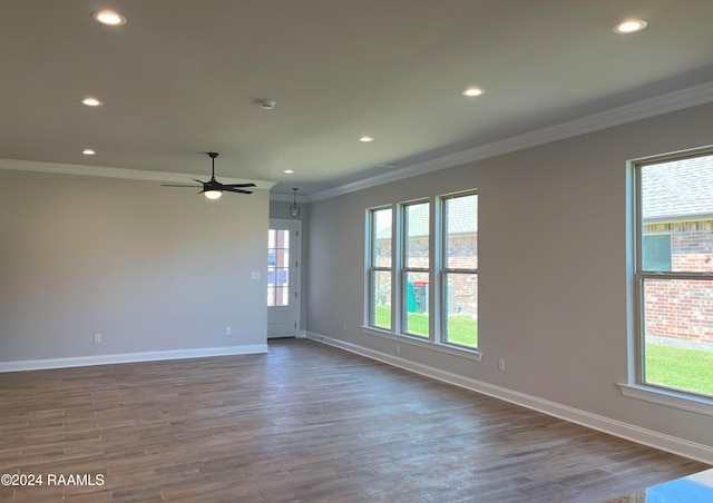 unfurnished room featuring dark hardwood / wood-style floors, ceiling fan, and crown molding