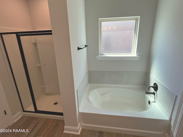 bathroom with separate shower and tub